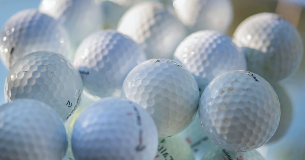 A table full of golf balls that are best for beginner golfers