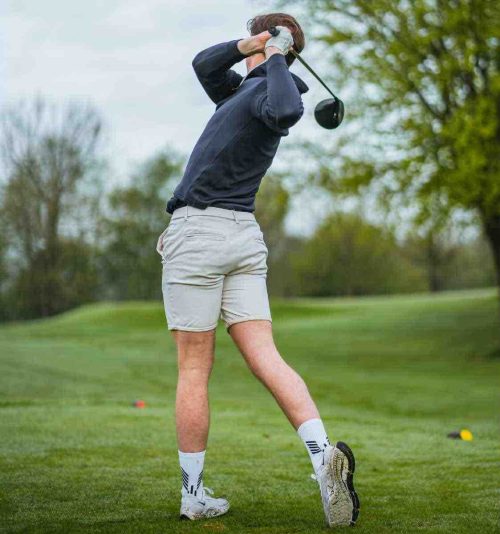 Male golfer in the following through on a shot with his driver